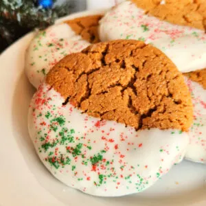 Gingerbread cookies dipped in white chocolate with red and green sprinkles