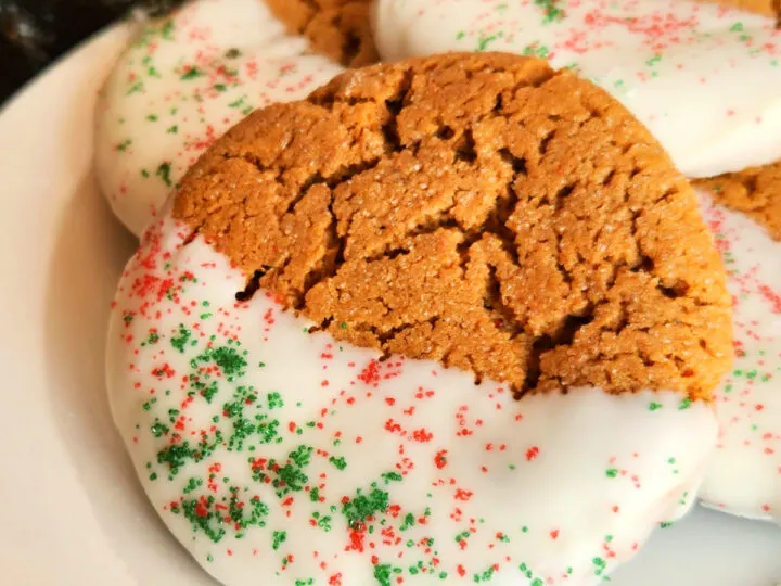 Gingerbread cookies dipped in white chocolate with red and green sprinkles