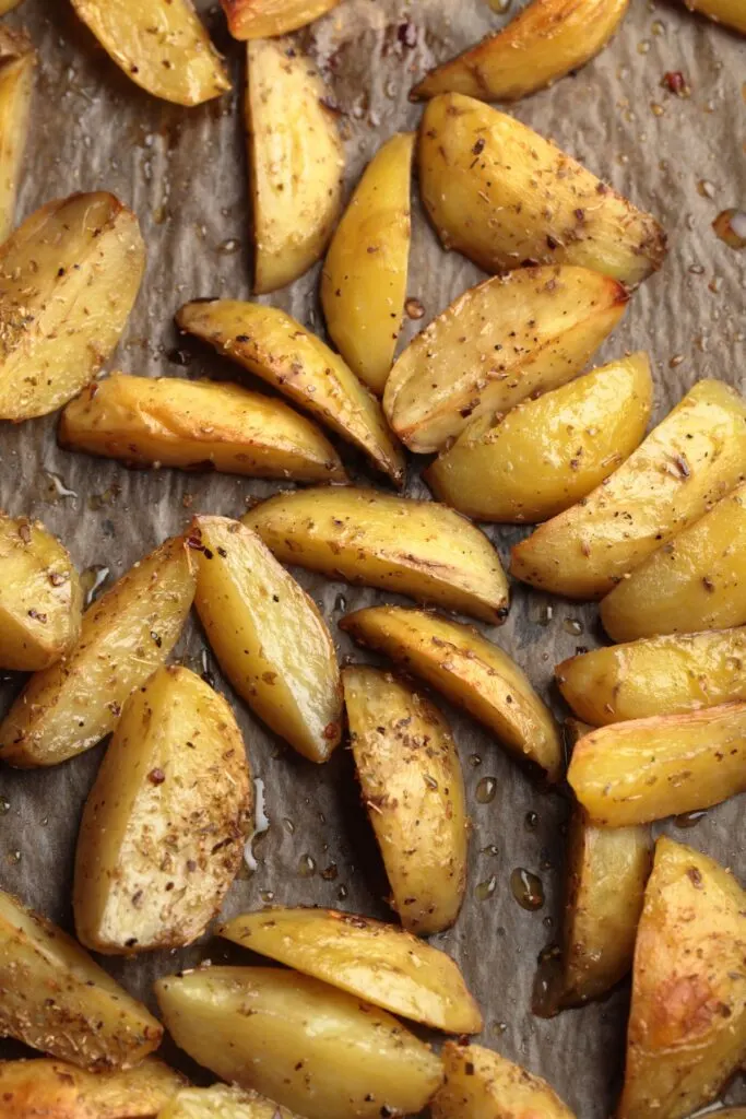 roasted potato wedges on parchment paper