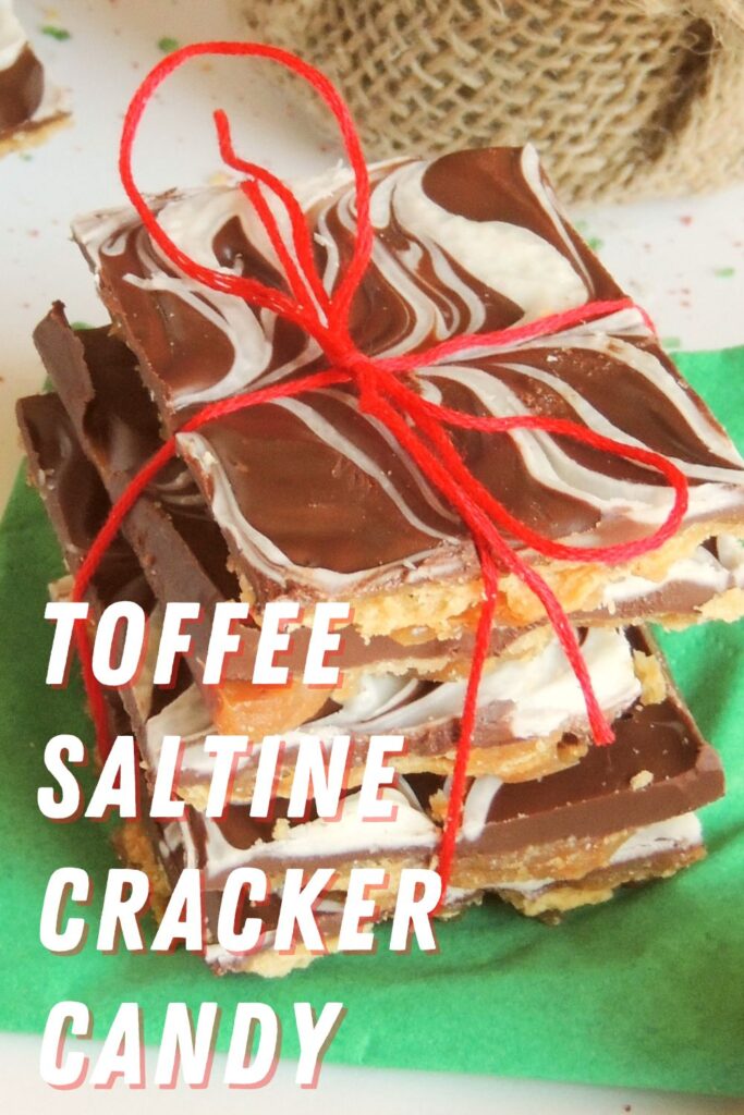Stack of toffee saltine cracker candy tied with red string on green napkin