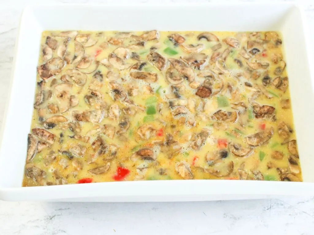cooked vegetables and egg mixture in baking dish