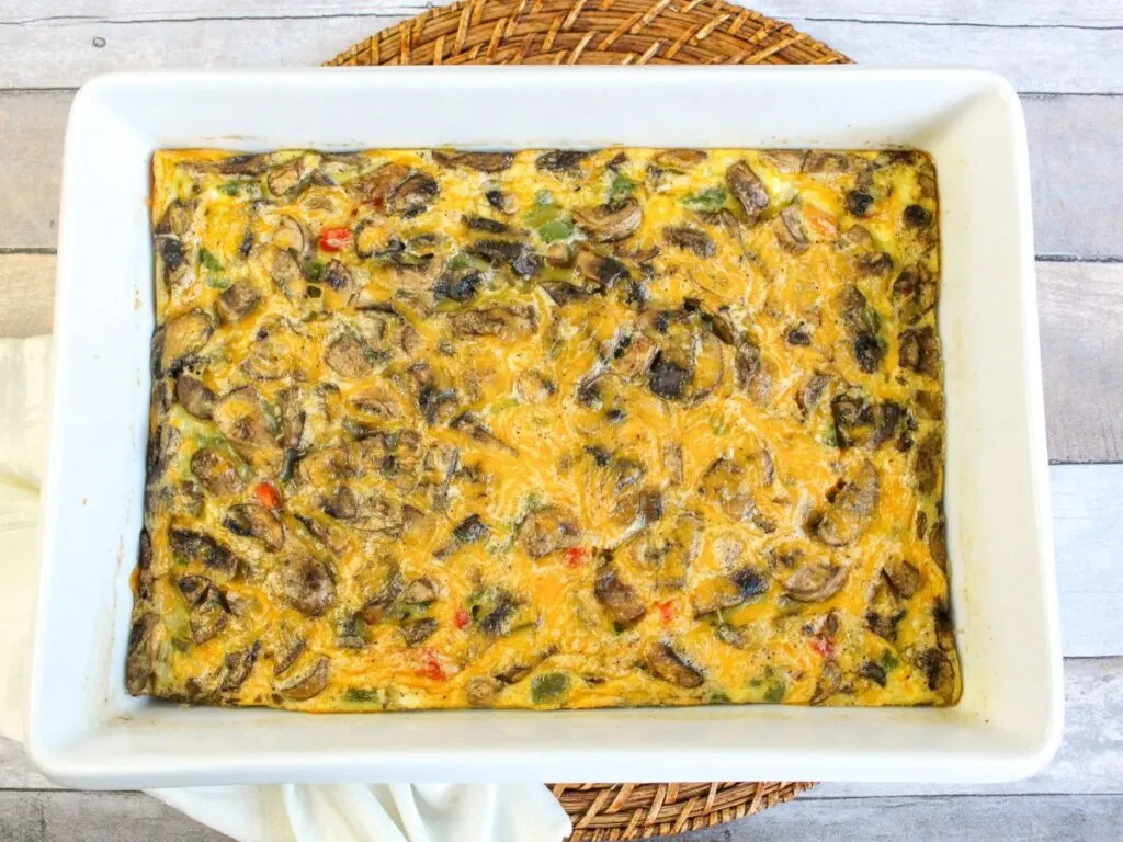Baked egg cheese vegetable casserole in white baking dish