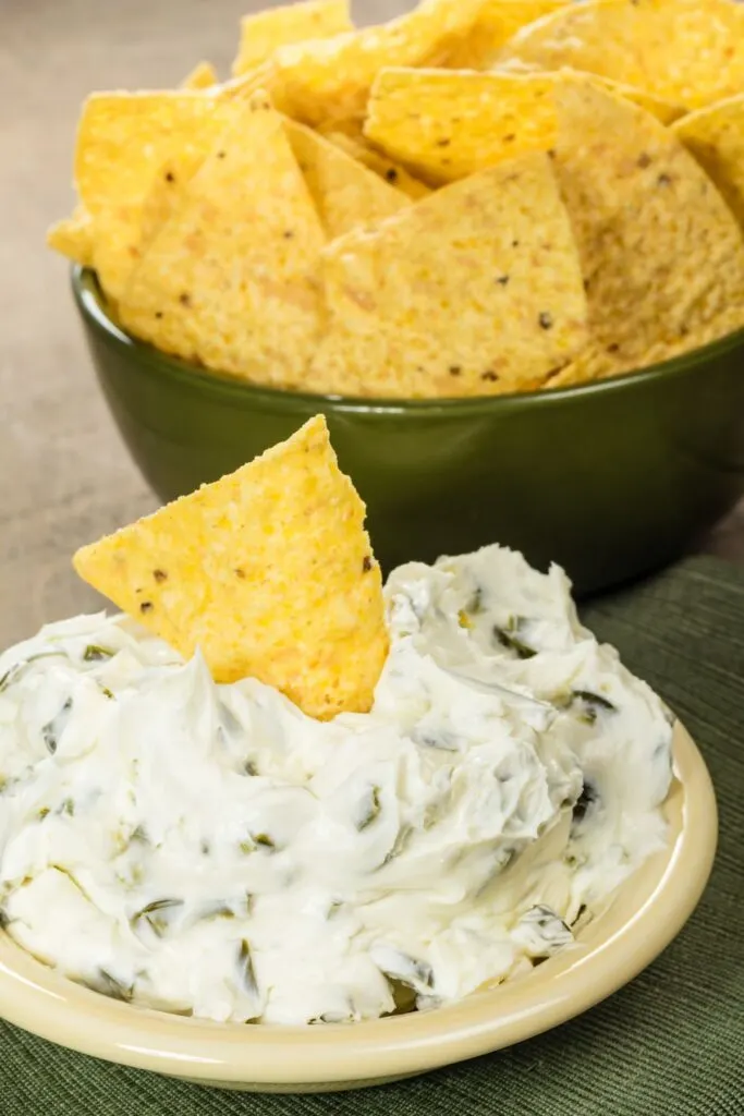 bowl of tortilla chips with bowl of cream cheese dip