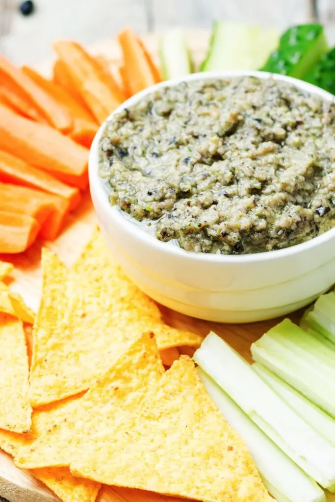 black bean dip with vegetable sticks and tortilla chips