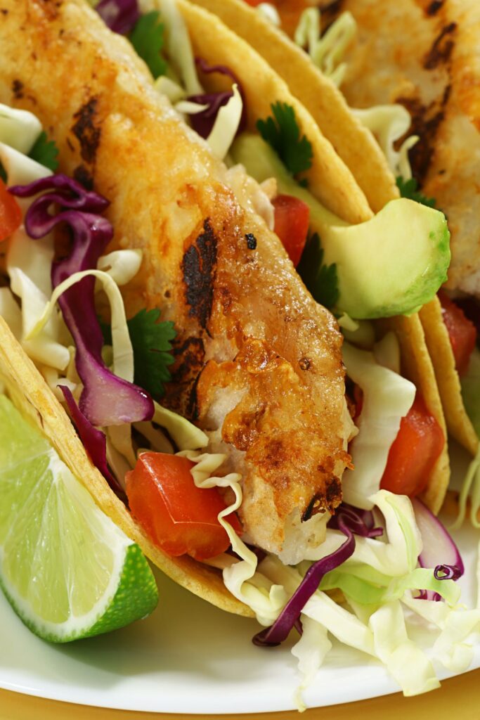 crispy fish tacos with avocado and cabbage