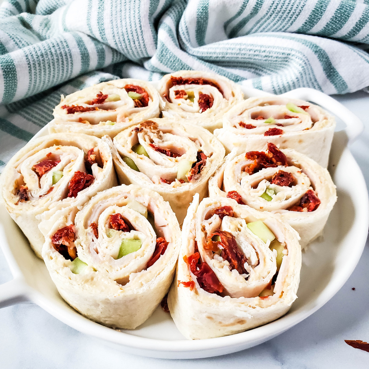 turkey hummus pinwheels with cucumber and sun dried tomatoes