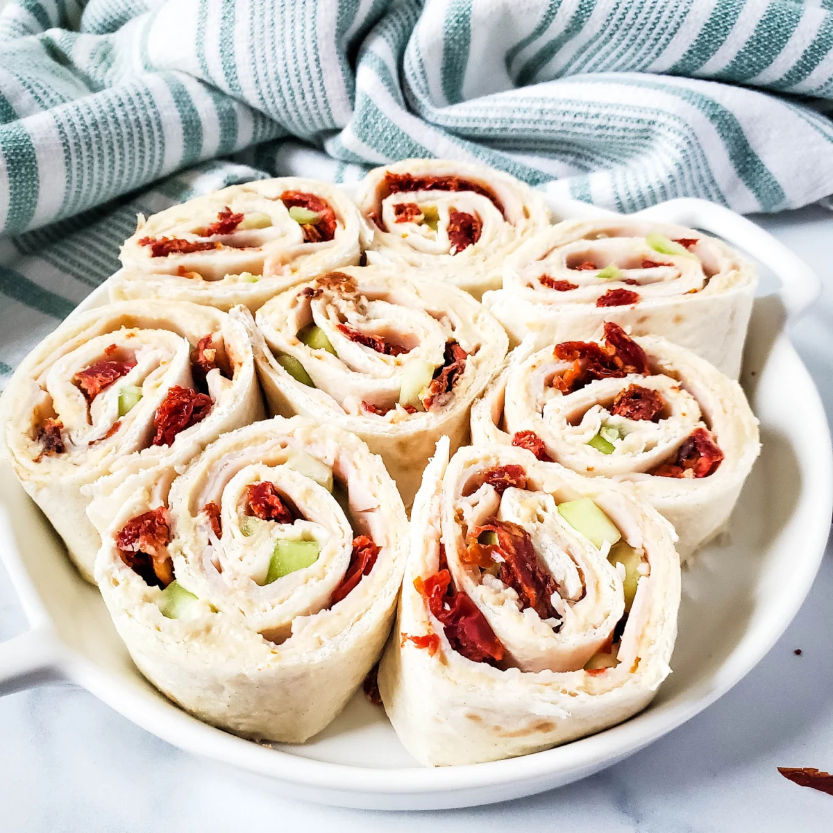 turkey hummus pinwheels with cucumber and sun dried tomatoes