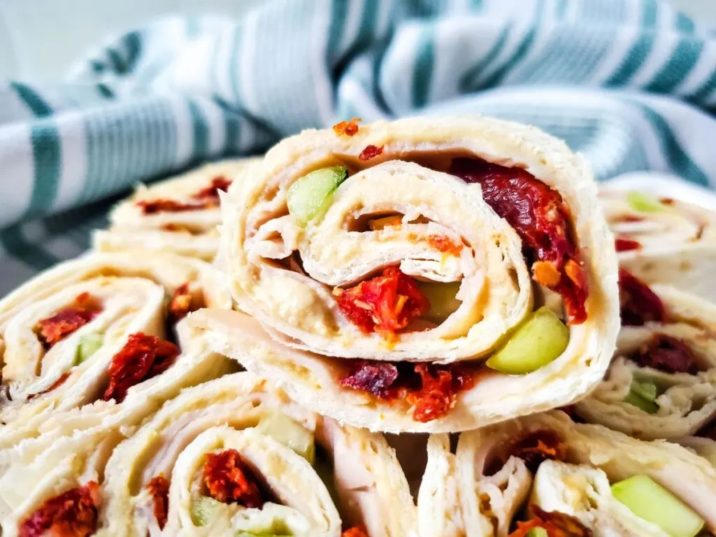 turkey hummus pinwheels with cucumber and sun-dried tomatoes