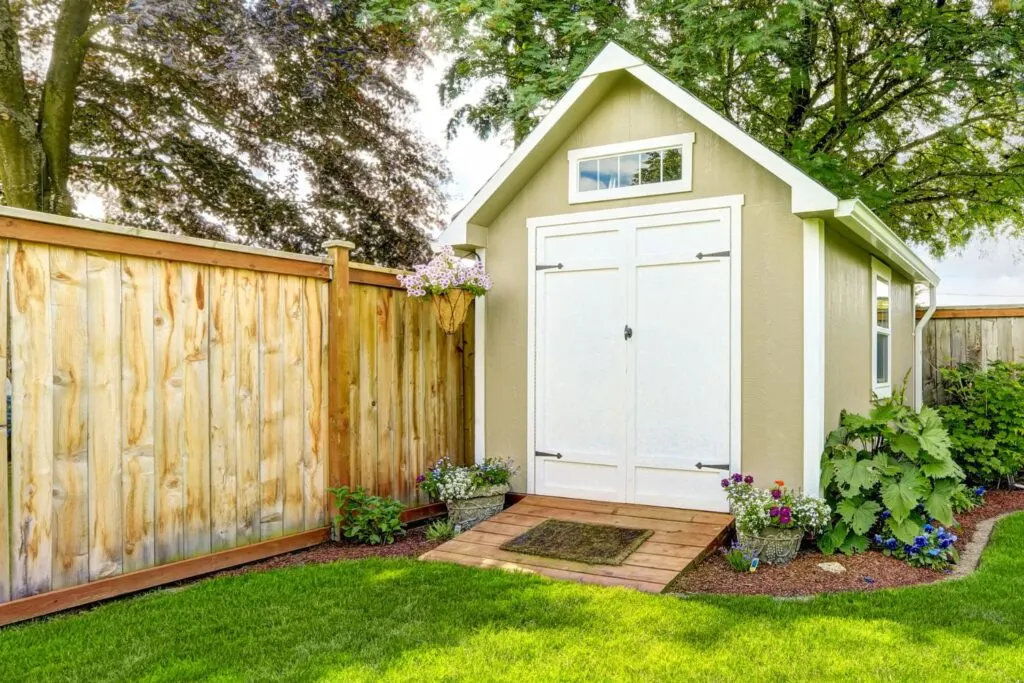 Backyard shed with fence and lawn