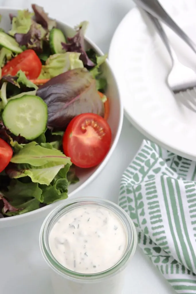 colorful salad in white bowl with homemade ranch
