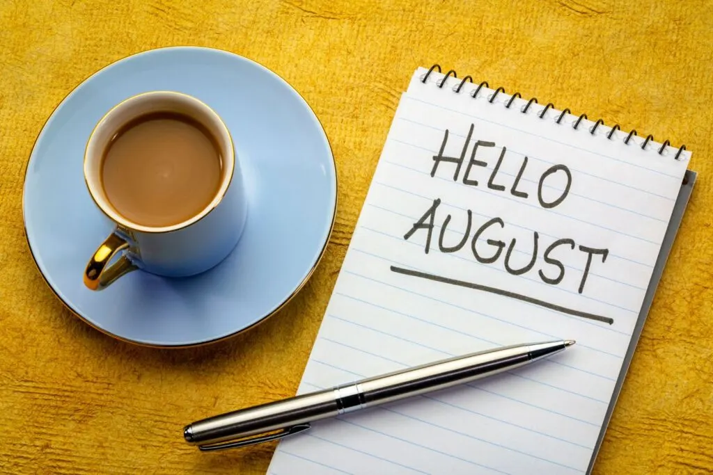 Hello August on notepad with blue tea cup and saucer