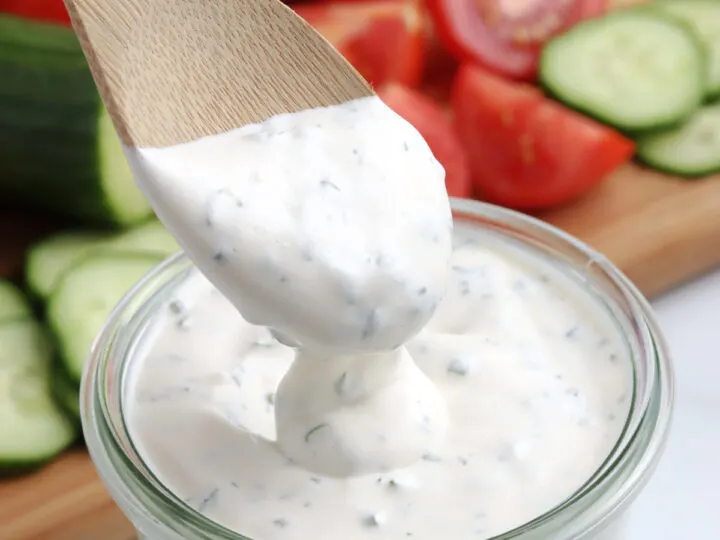 homemade ranch dressing in glass jar with wooden spoon