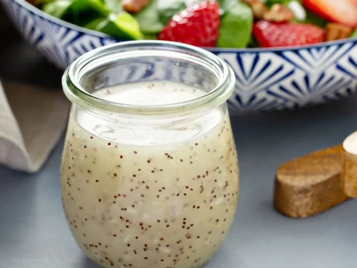 homemade poppy seed dressing in open glass jar