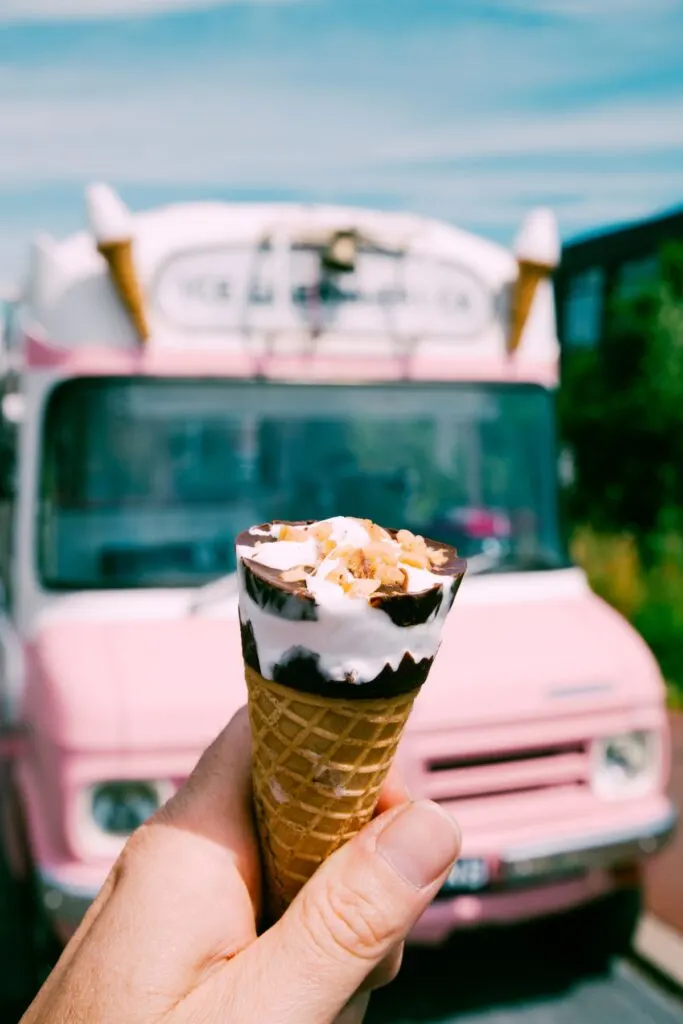 ice cream cone in front of pink ice cream truck