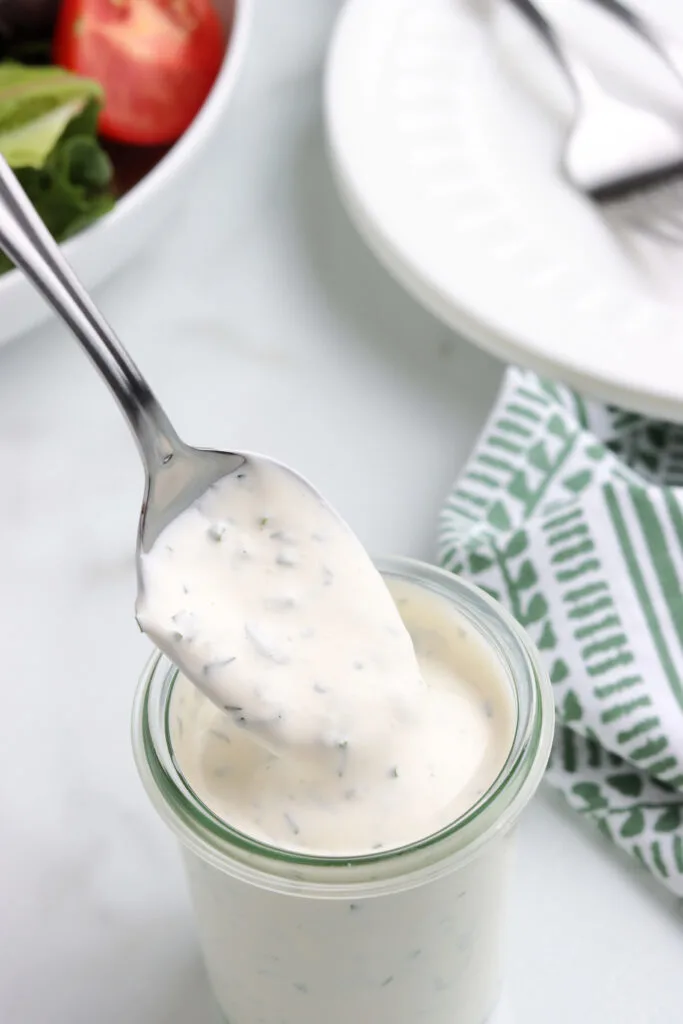 spoonful of homemade ranch dressing in glass jar