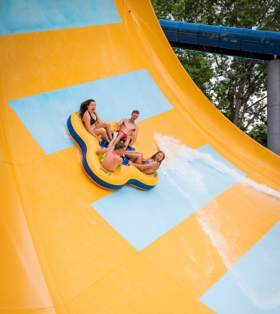 Teens riding Water Country USA slide
