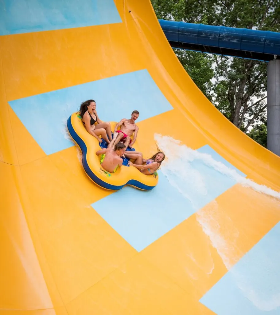 Teens riding Water Country USA slide