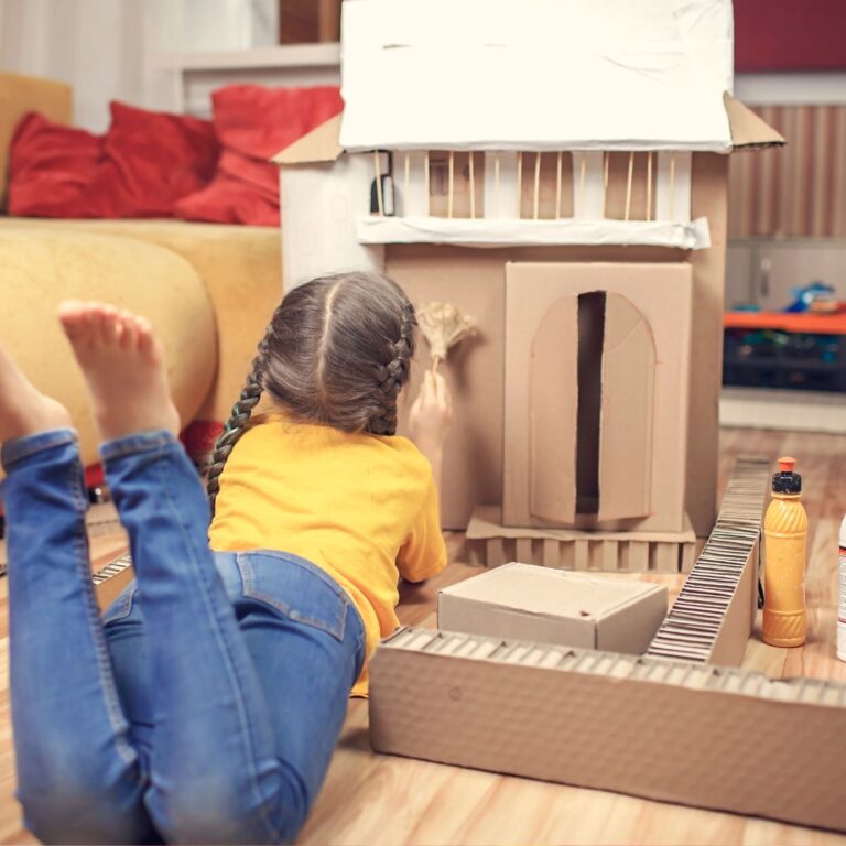 kid playing with architecture building kit
