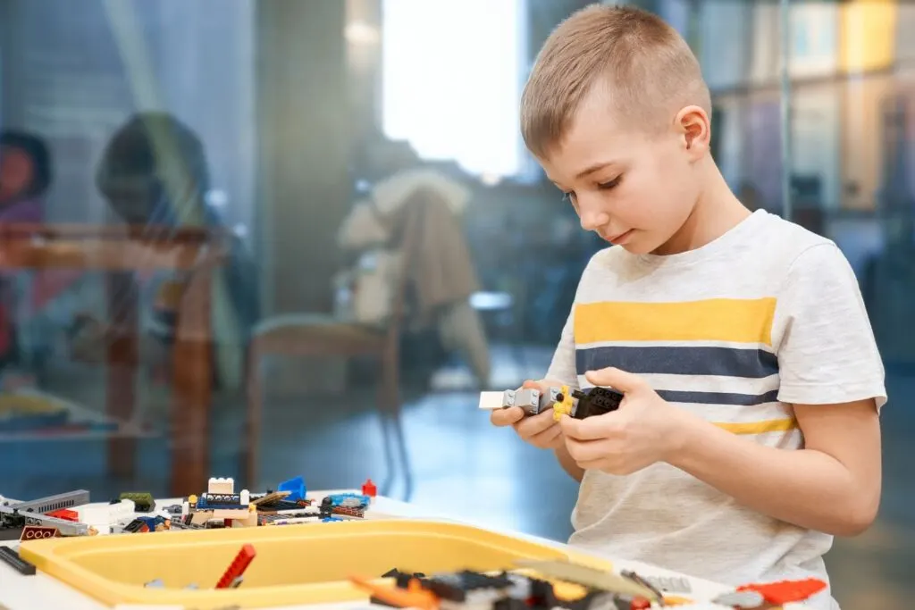 kid playing with architecture building kit