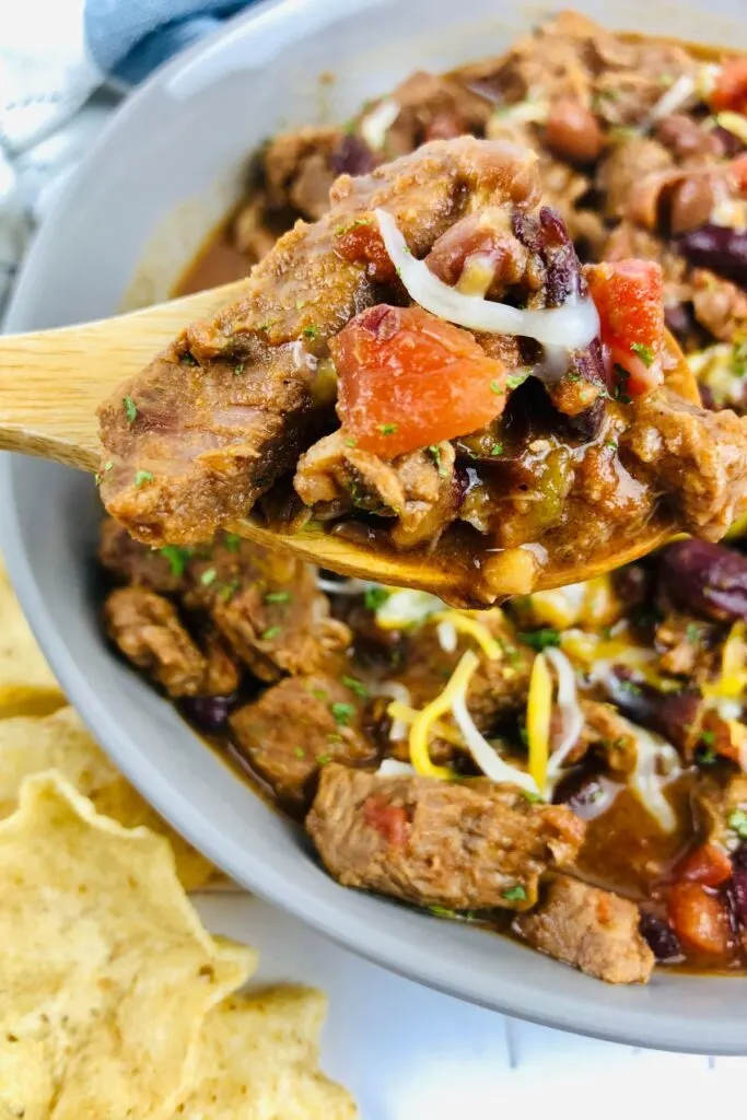 spoonful of easy chili with beef chunks made in slow cooker