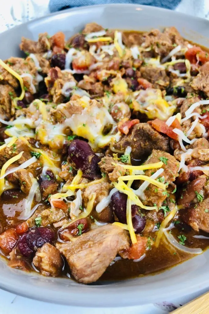 stew beef chili topped with shredded cheese