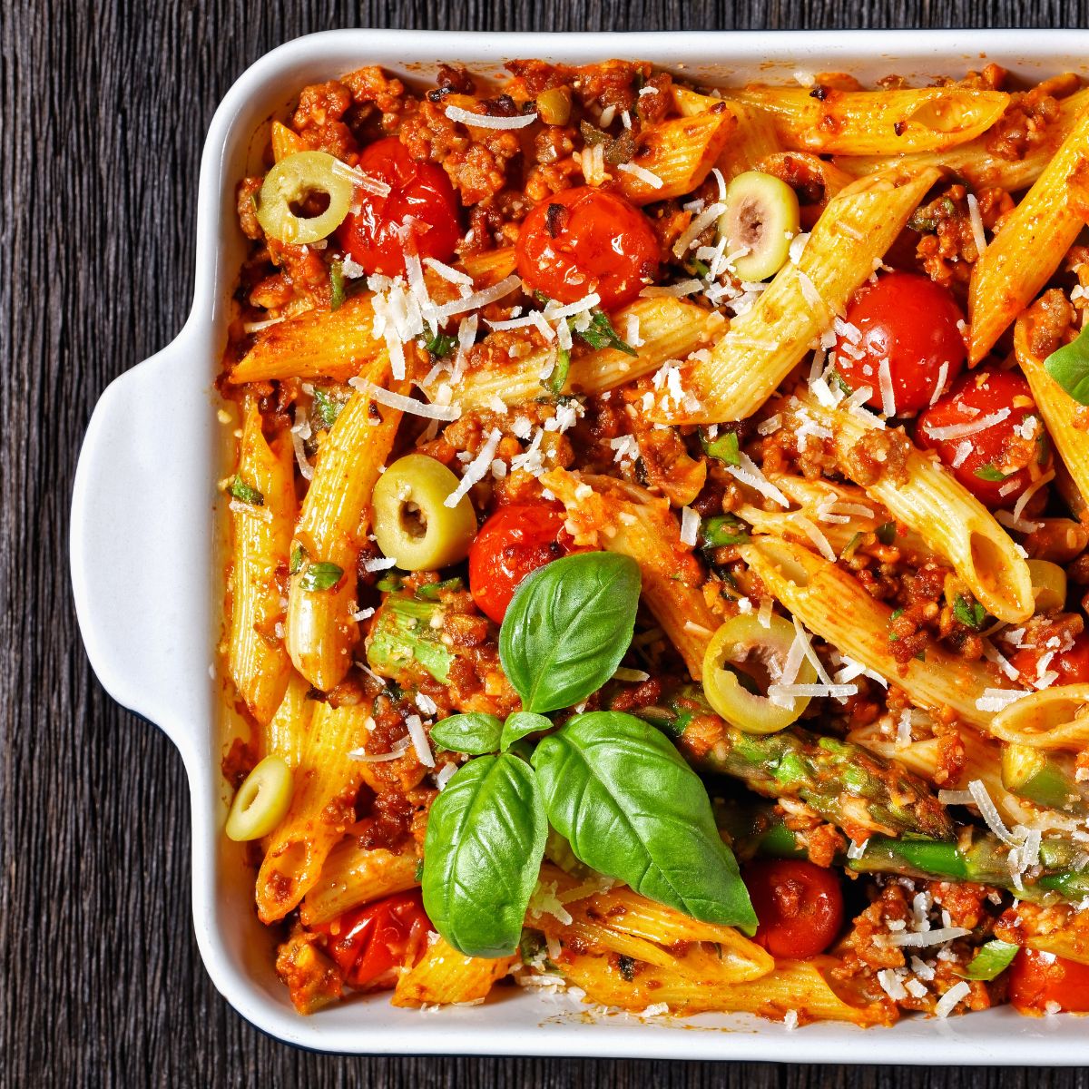penne with vegetables and turkey in white baking dish