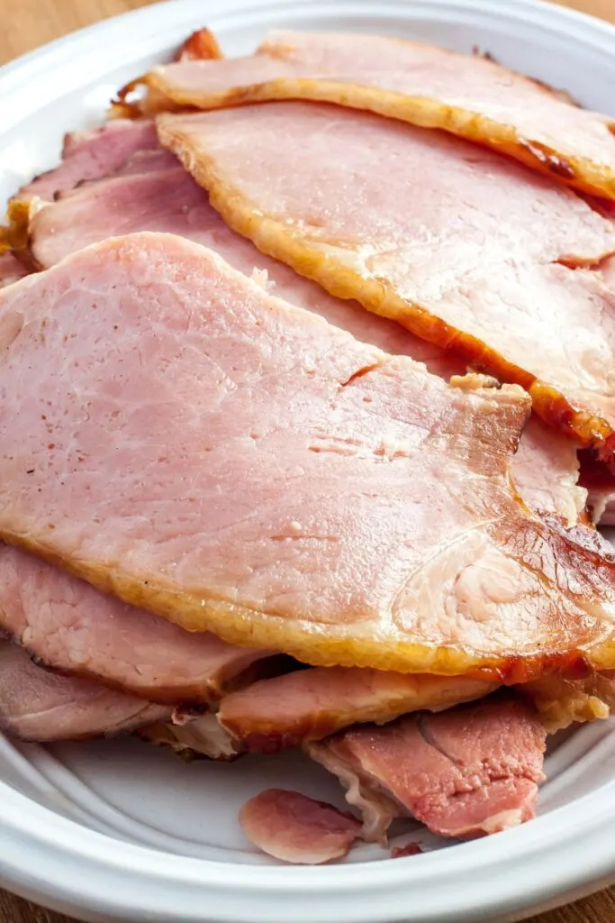 slices of spiral ham leftovers on white platter