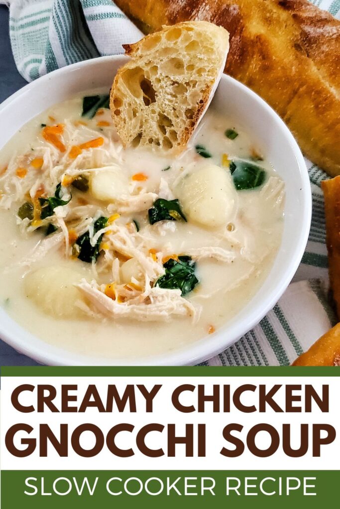 White bowl of creamy chicken gnocchi soup with slice of bread